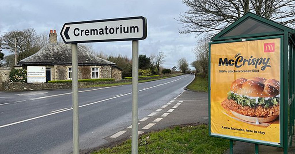 Example of a bad billboard design from McDonalds who advertised a McCrispy next to a crematorium sign.